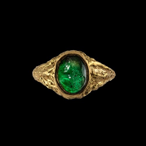 A Roman green chalcedony intaglio set in a gold ring.